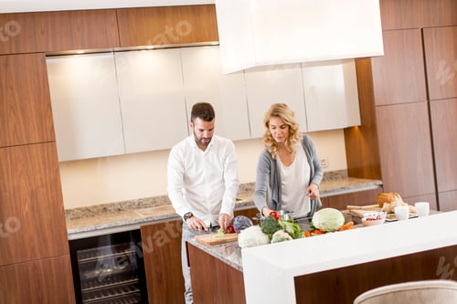 Preview: Young man helping his girlfriend cooking