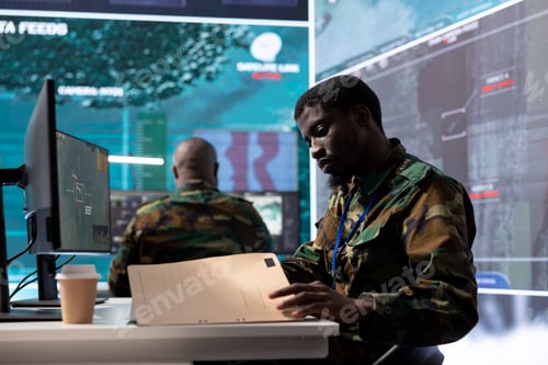 Preview: Military man in command center uses advanced technology and classified documents