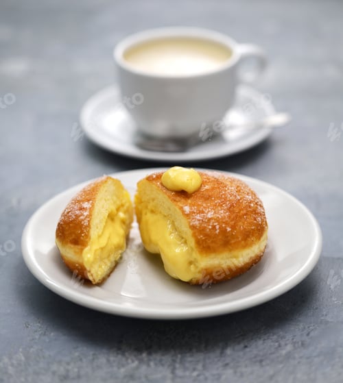 Preview: homemade Bomboloni filled with custard, Italian stuffed donuts.