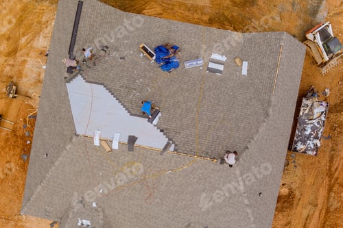 Preview: The roofing worker from the construction company installed the new shingles on the roof of the house