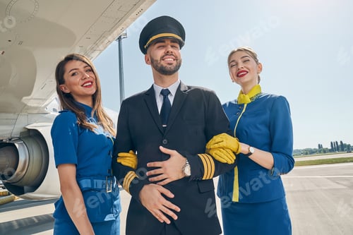 Preview: Modern young cabin crew smiling at the camera