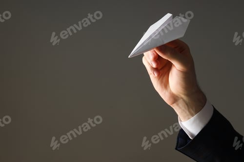 Preview: Businessman hand with paper plane on gray background