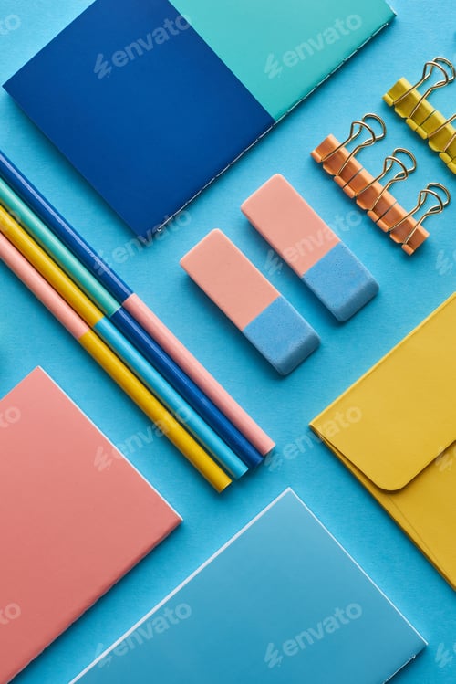 Preview: top view of notebooks and colorful stationery isolated on blue