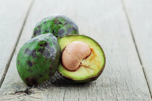Preview: Ripe Avocado Halves on Distressed Wood Surface