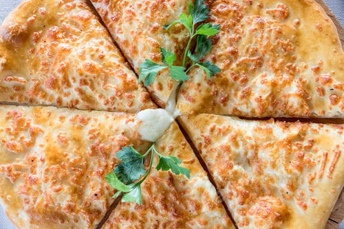 Preview: traditional food, khachapuri mingrelian with sulguni cheese. Georgian traditional flatbread -