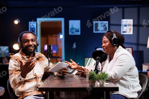 Preview: Man laughs with guest during podcast