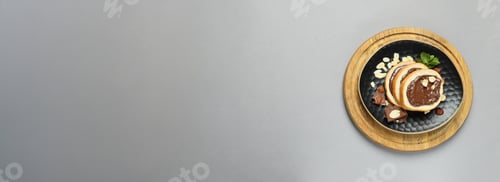 Preview: Bread with chocolate paste in a bowl on a gray background
