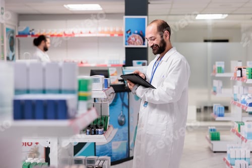 Preview: Drugstore employee holding tablet computer checking client prescription