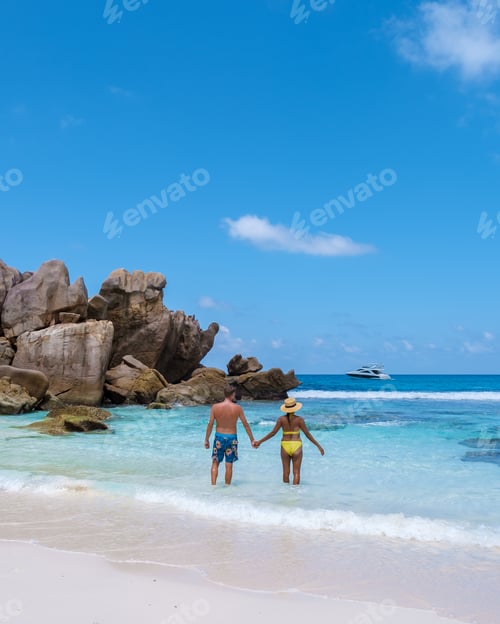 Preview: Anse Cocos La Digue Seychelles, a young couple of men and women on a tropical beach during vacation