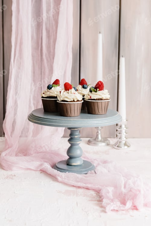 Preview: Delicious chocolate muffins with raspberry, blueberry and strawberry cream.