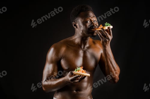 Preview: Sexy African enjoying pizza slices. Hot delivery for stay-home customers