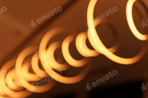 Preview: blurred hanging rings or circle bulb. abstract lighting modern geometry lamp glowing golden light