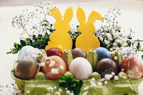 Preview: Natural dyed easter eggs and rabbit decorations on wooden background