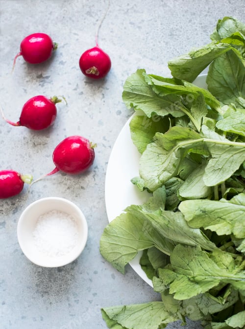 Preview: top view of radishes and plate of radish leaves