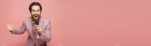 Preview: Stylish host of event holding microphone and waving hand at camera isolated on pink, banner
