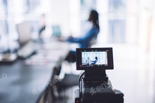 Preview: View of office worker through camera