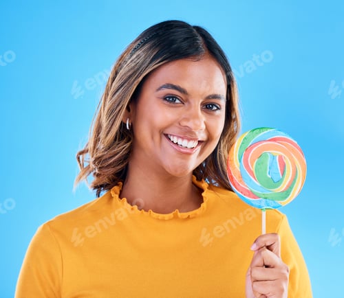 Preview: Portrait, lollipop and a woman on a blue background in studio wearing heart glasses for fashion. Sm