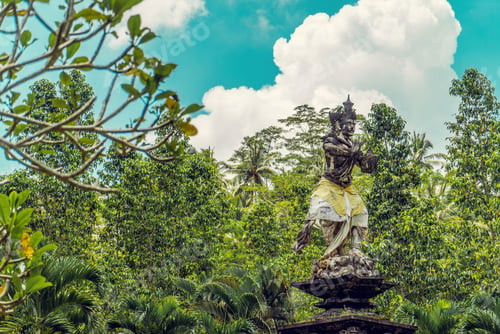 Preview: Ancient Balinese statue in a lush green park in Bali