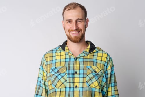 Preview: Portrait of happy young bearded hipster man smiling