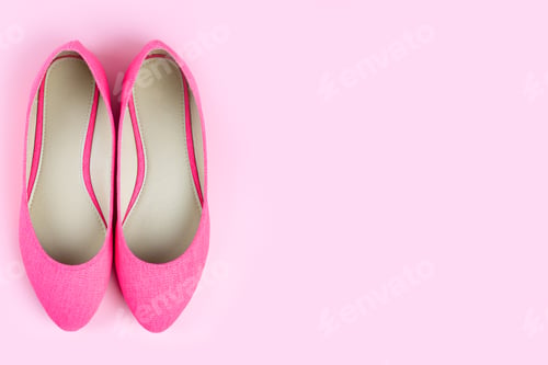 Preview: Pair of pink classic elegant shoes isolated on pink background with copy space