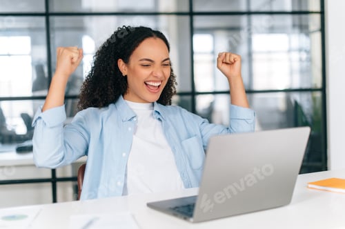 Preview: Amazed excited brazilian or hispanic businesswoman, company employee, rejoicing in a big success