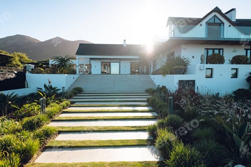 Preview: Steps amidst plants leading towards nursing home against clear sky during sunny day, copy space