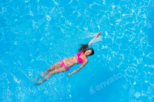 Preview: A girl is relaxing in a swimming pool