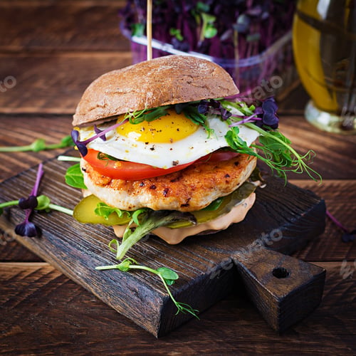 Preview: Sandwich with chicken burger, tomatoes, pickled cucumber and fried egg.