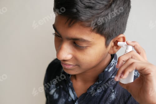 Preview: Close up of men using spray to remove earwax