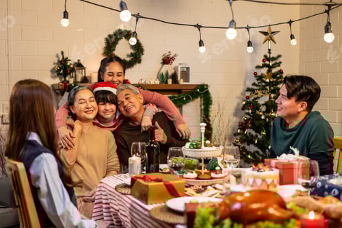 Preview: Asian kid hugging grandparent while celebrate Christmas party in house.