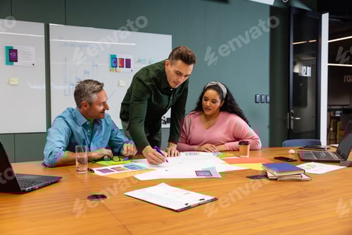 Preview: Multiracial businessmen and businesswoman discussing strategy in meeting at creative office