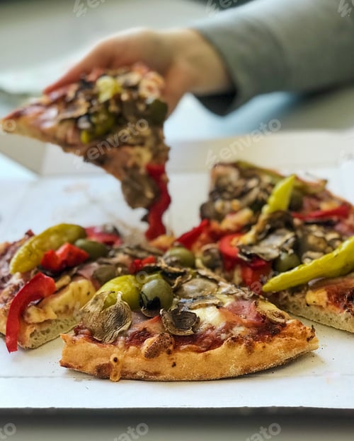 Preview: Woman enjoying a piece of takeout pizza