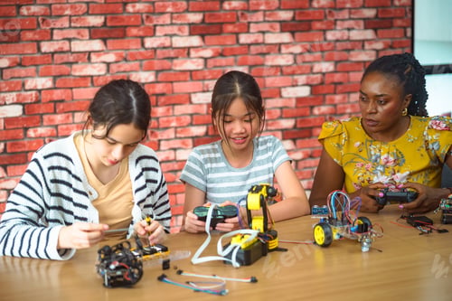 Preview: Diverse group of children and adult learning robotics and engineering in a classroom setting