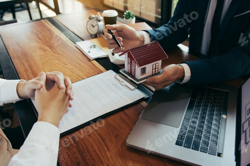 Preview: New home buyers are signing a home purchase contract at the agent's desk.