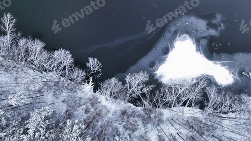 Preview: Flight over snowy forest and lake in Poland.