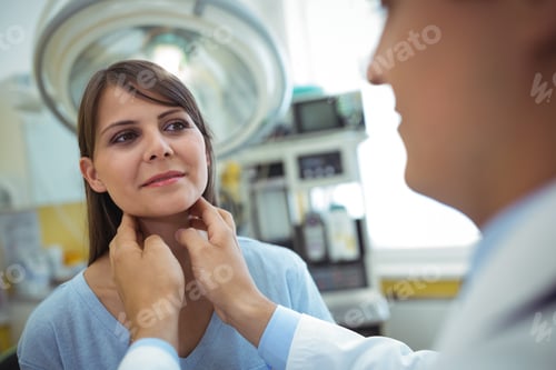 Preview: Doctor examining a female patients neck
