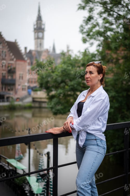 Preview: Stylish mature woman strolling around the city in a beige coat
