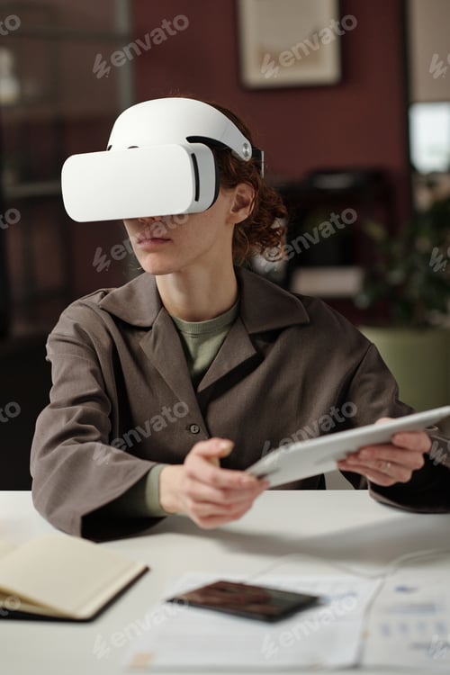 Preview: Young Woman Using VR Headset At Work