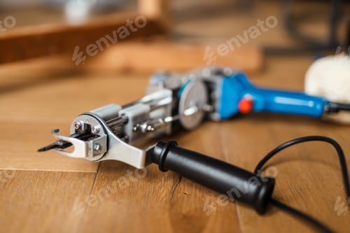 Preview: Tufting Gun Close Up on Wooden Surface