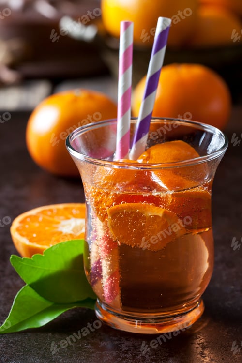 Preview: Fruit spritzer of tangerines in a glass with drinking straws