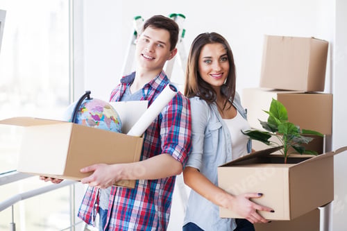 Preview: Young happy couple moving into their new home. They unpacking and cleaning new home