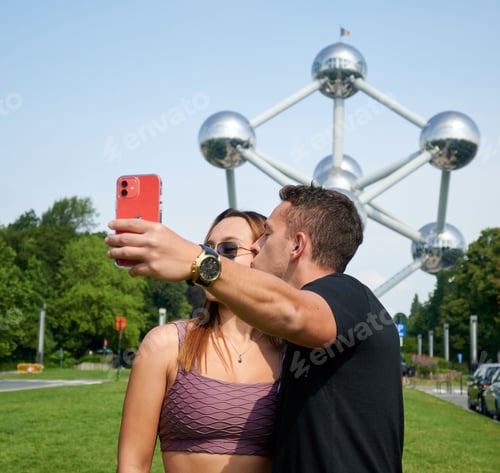Preview: Young Hispanic couple taking a selfie at Atomium, Brussels, Belgium