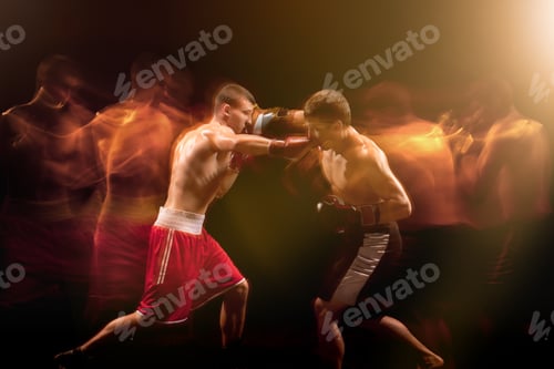 Preview: The two male boxers boxing in a dark studio