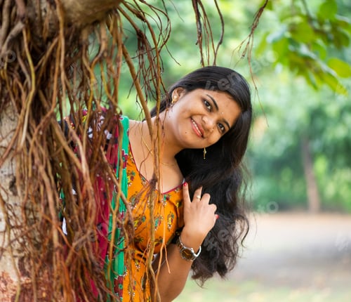 Preview: Happy woman near banyan tree