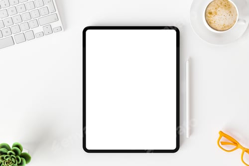 Preview: Top view of blank screen tablet on white working desk