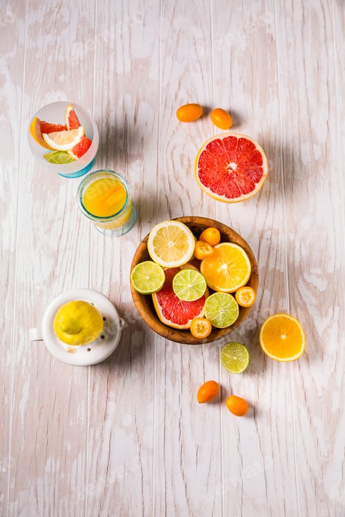 Preview: Assortment of citrus fruits on wooden background. Preparing lemonade, ice tea or summer drink.