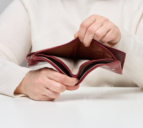 Preview: Two female hands hold an empty brown leather wallet, poverty