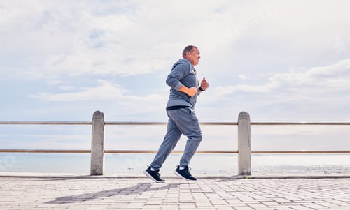 Preview: Senior man running outdoor at beach promenade, sky mockup and energy for body, wellness and cardio