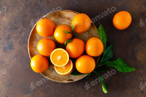 Preview: Oranges with leaves on dark background, top view