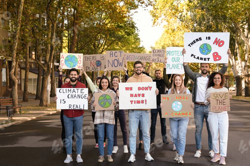 Preview: Group of people with posters protesting against climate change on city street